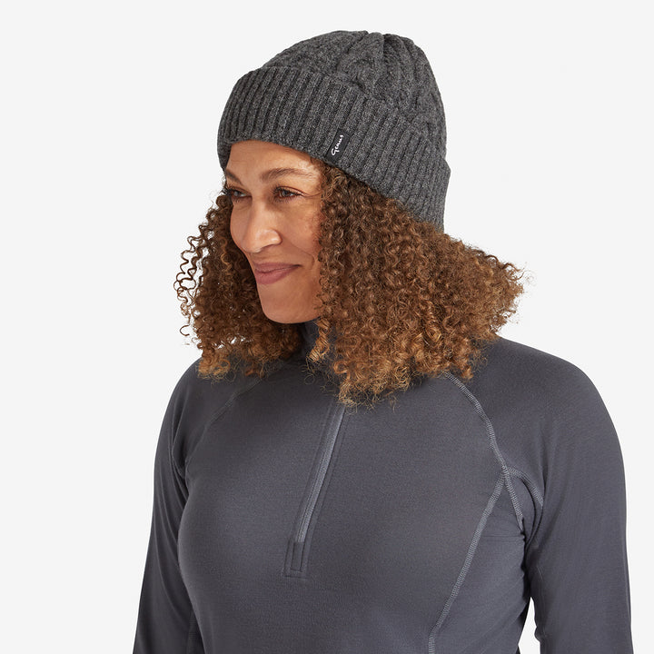 Woman wearing a Dark Earth Genus Cable Knit Merino Wool Hat 