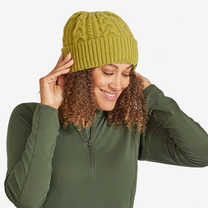 Woman wearing an Achemilla Green Genus Cable Knit Merino Wool Hat 