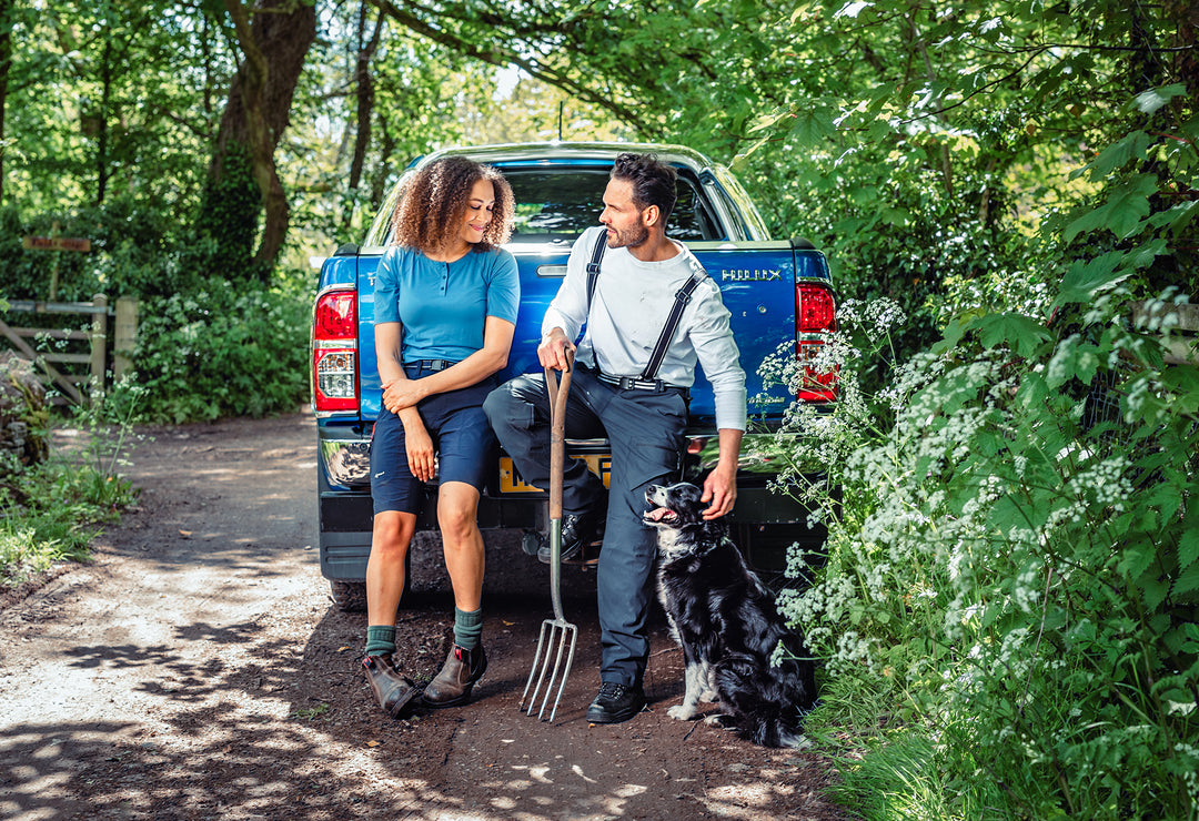 Man petting his dog wearing the Genus Gardening Braces