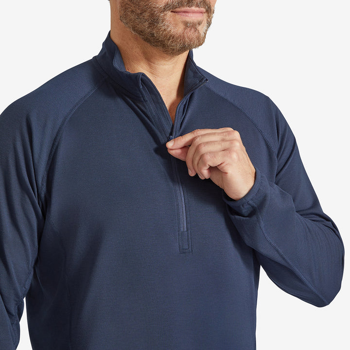 Man holding the zip on a Genus Men's Marine Blue Eden Zip Neck Top 