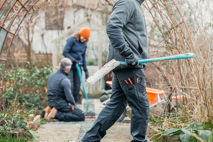 Man wearing the Genus Men's Gardening Propants in the garden