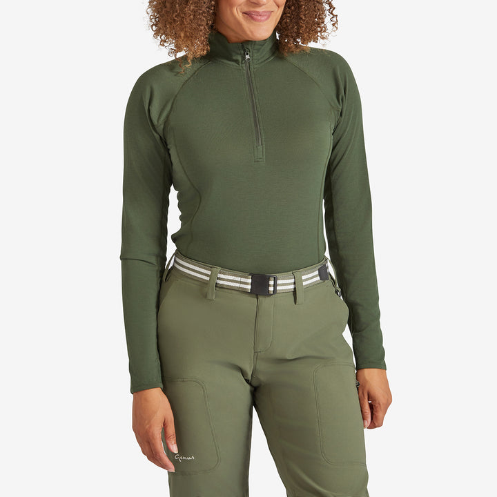 Woman wearing a Genus Women's Dark Green Eden Zip Neck Top tucked in