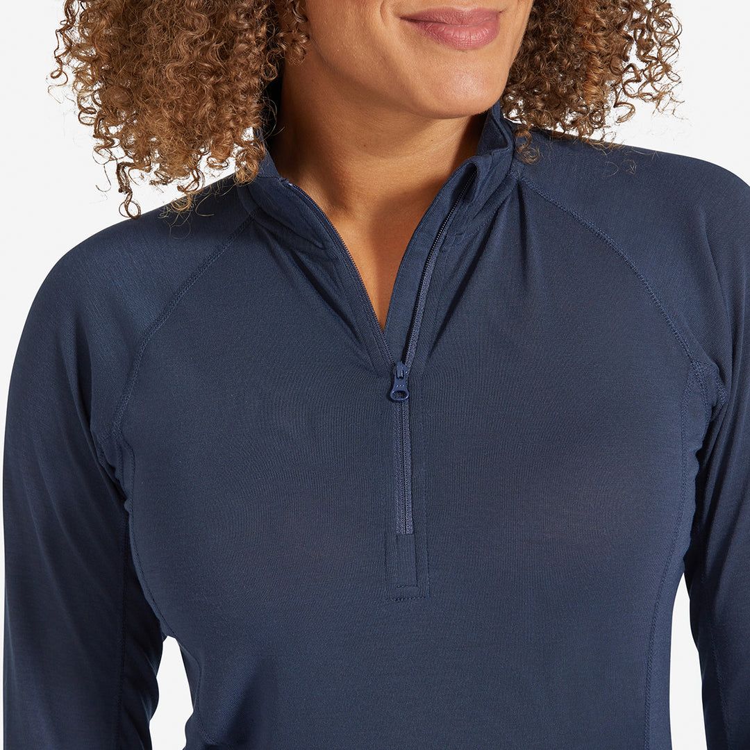 Woman showing the collar of a Genus Women's Marine Blue Eden Zip neck Top