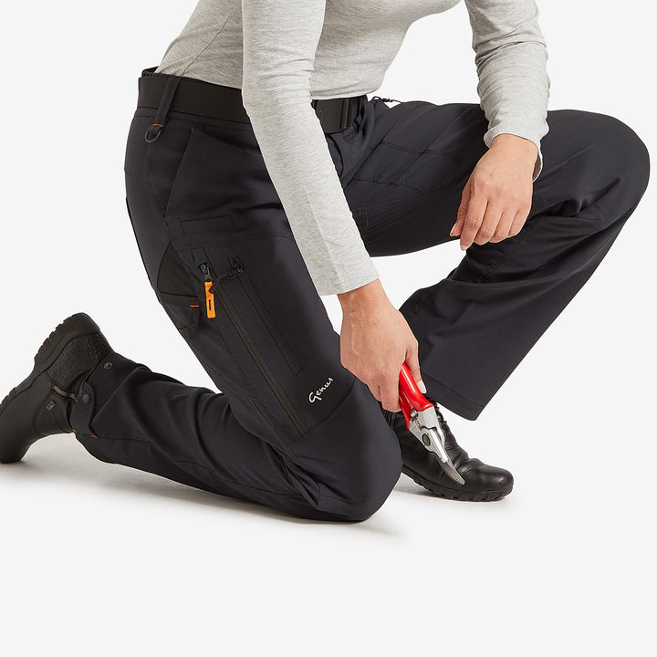 Woman kneeling down in the Genus Women's Gardening Propants
